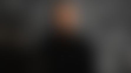 Joe Budden posing for Variety with a black and white background