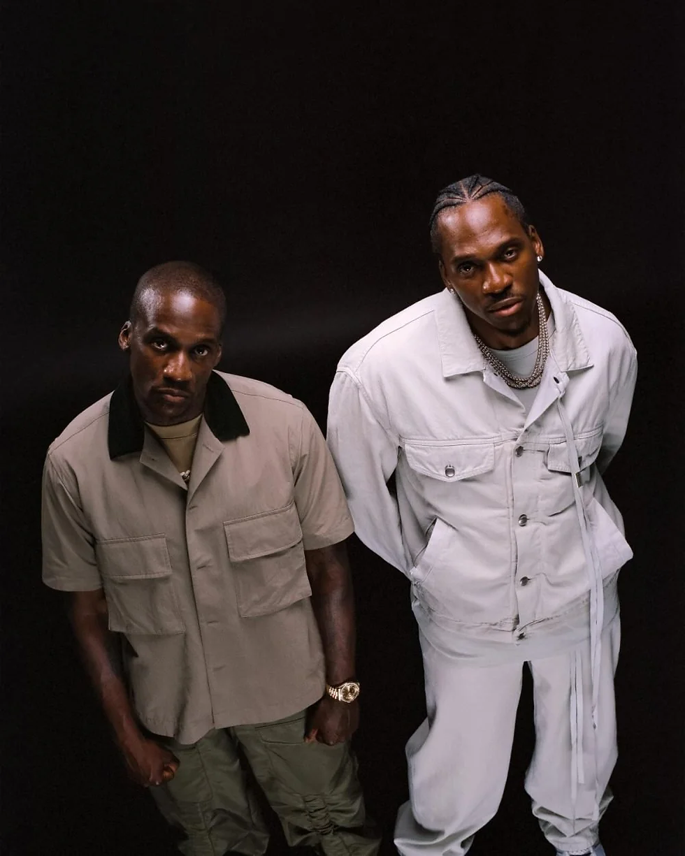 Clipse members Pusha T and No Malice pose in coordinated outfits ahead of their 2025 album release, Let God Sort 'Em Out.
