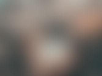 A hand holding a glass ball reflecting nature