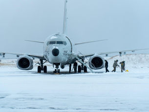 P-8 Poseidon maritime patrol aircraft operating from a snowy airfield in Iceland