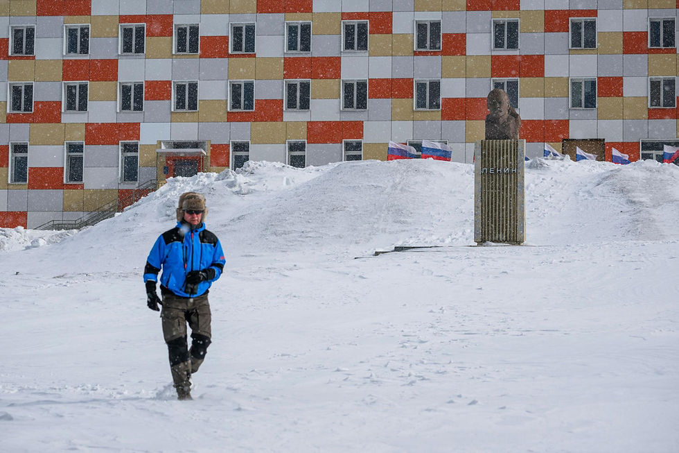 Person walking through Barentsburg during winter in the Russian Arctic settlement of Svalbard
