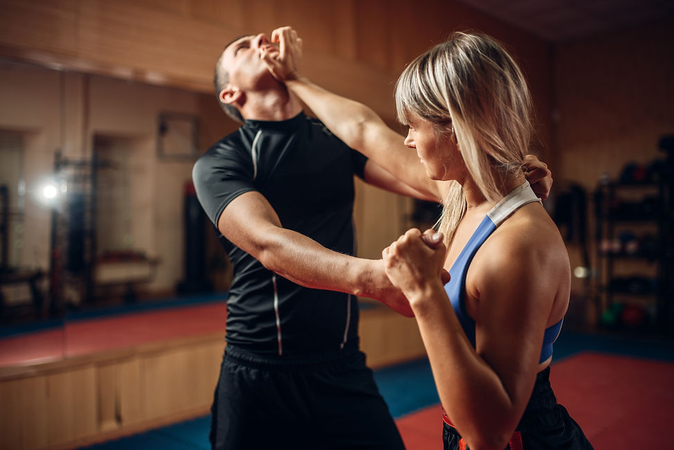 Female person on self-defense workout with trainer.jpg