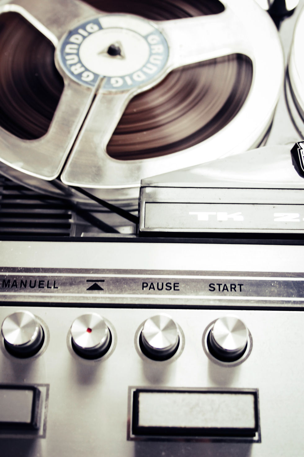 Recording device with reel tape and buttons for start and pause.