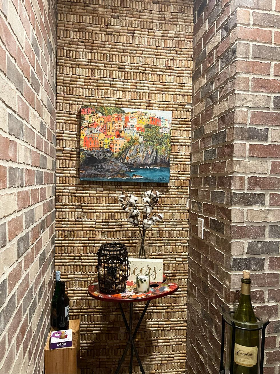 Custom wine cellar feature wall in Smyrna, GA home, showcasing decorative wine cork accent wall, brick finishes, and curated wine display area. 