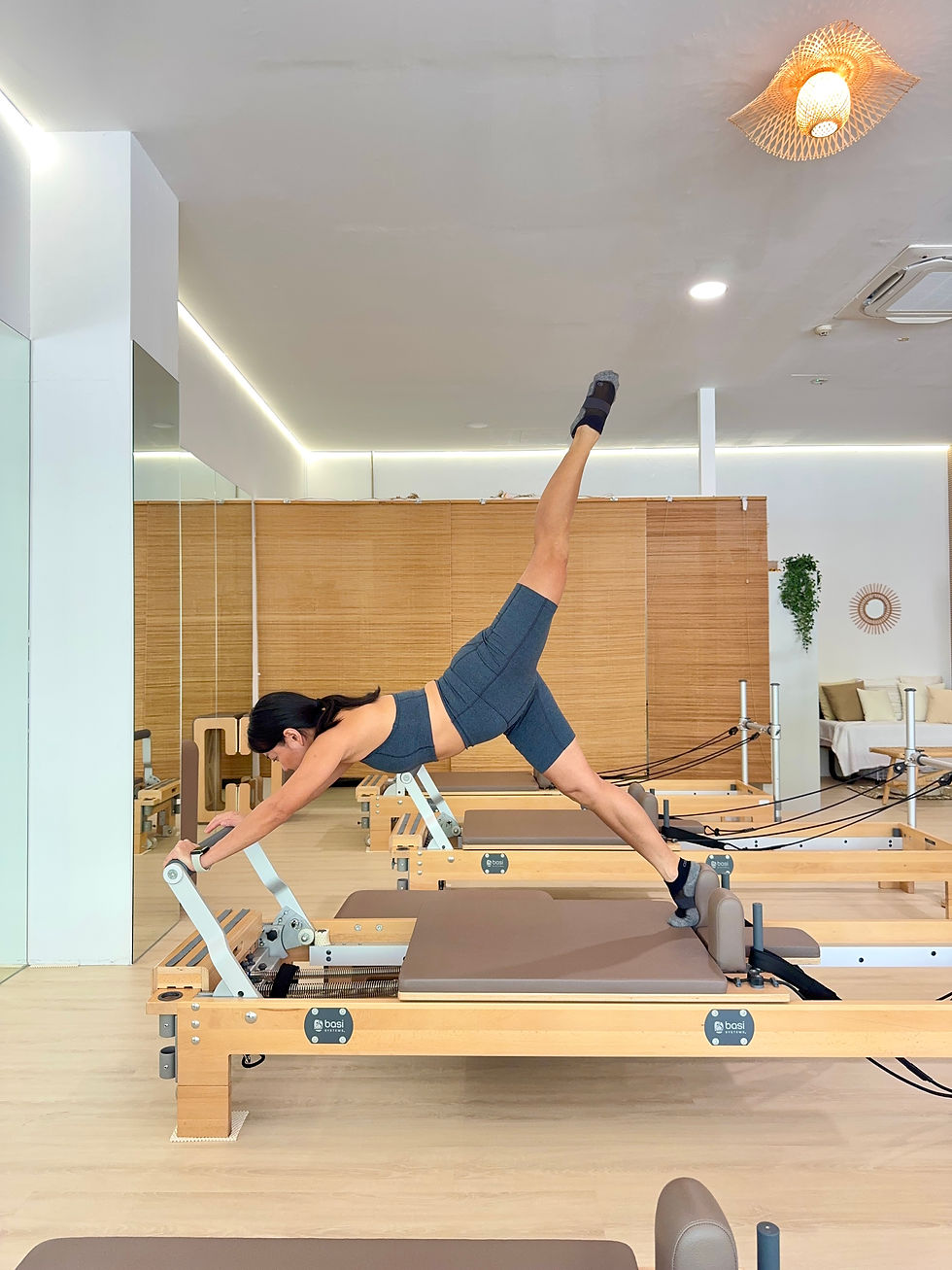 Eye-level view of a Pilates reformer machine in a bright studio