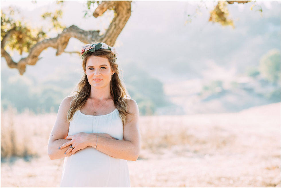 Pregnant mom wearing white dress and flower crown in Los Altos, Ca