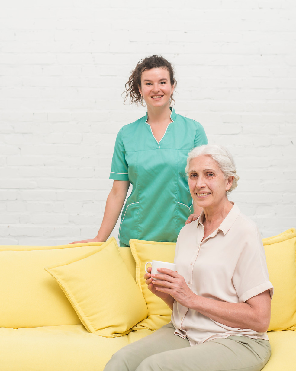 smiling-senior-woman-sitting-sofa-holding-coffee-cup-front-nurse.jpg