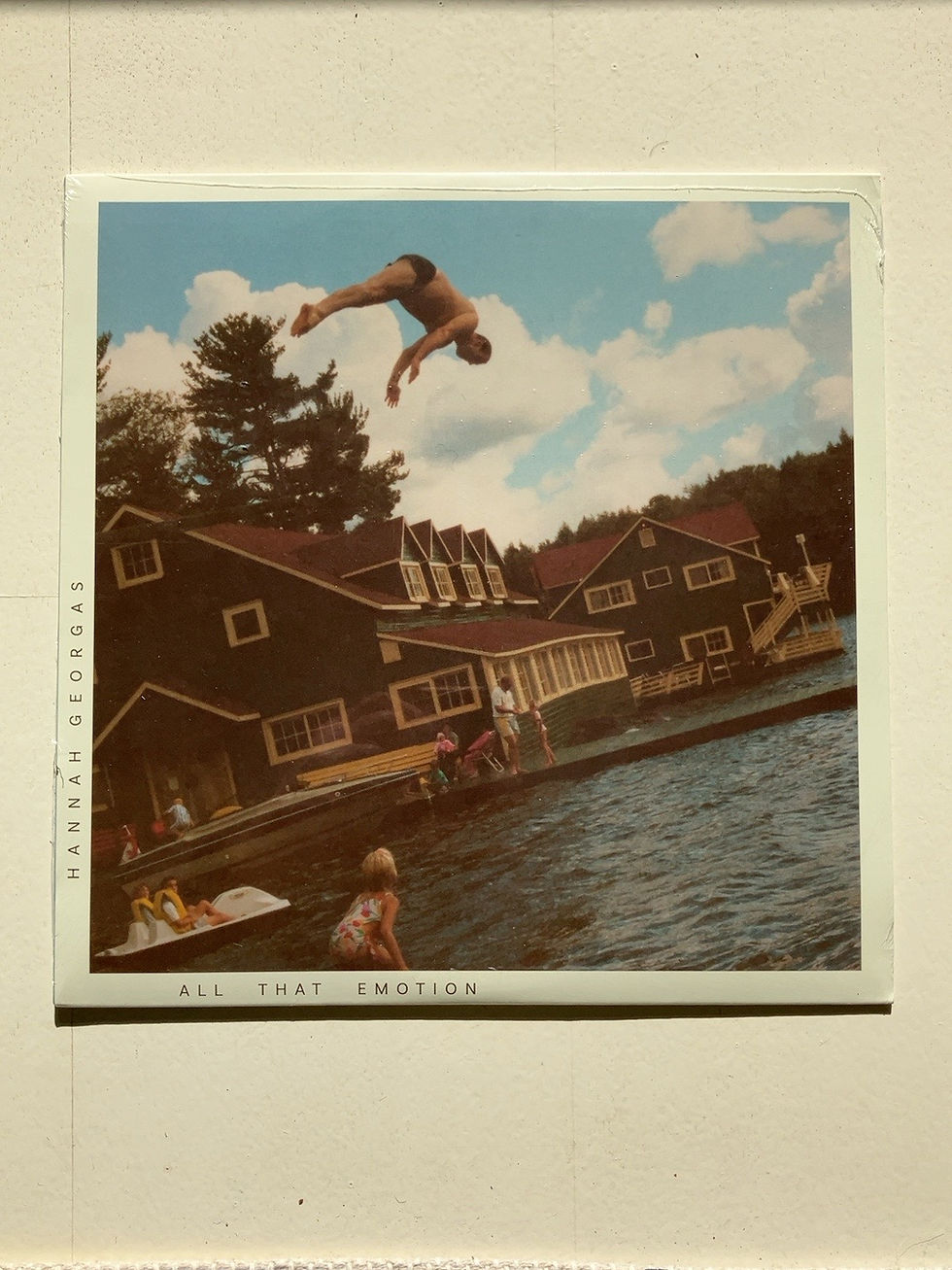Hannah Georgas – All That Emotion, front cover photograph of lakefront buildings and a person jumping