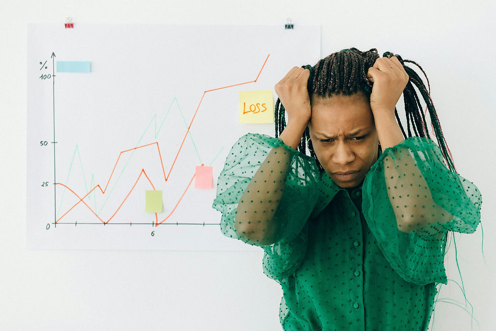 Person in green shirt holds head in frustration next to a chart showing a downward trend labeled "Loss." Graph has colorful sticky notes.