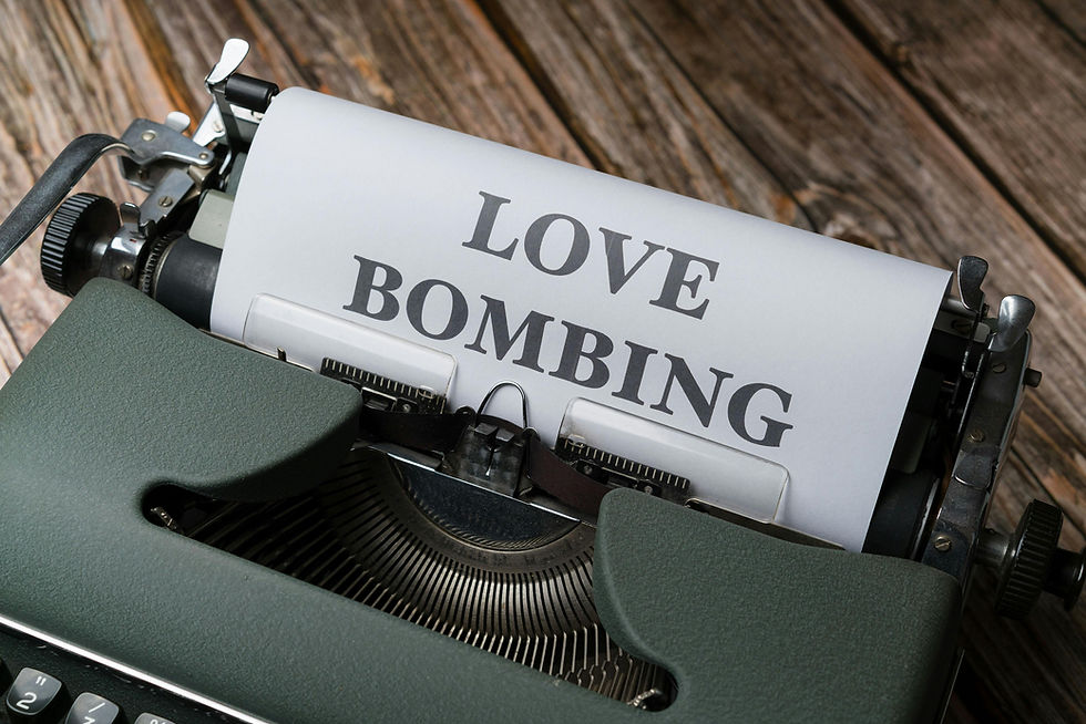 Close-up of a vintage typewriter with a white paper reading "LOVE BOMBING," set on a rustic wooden surface, evoking a nostalgic mood.