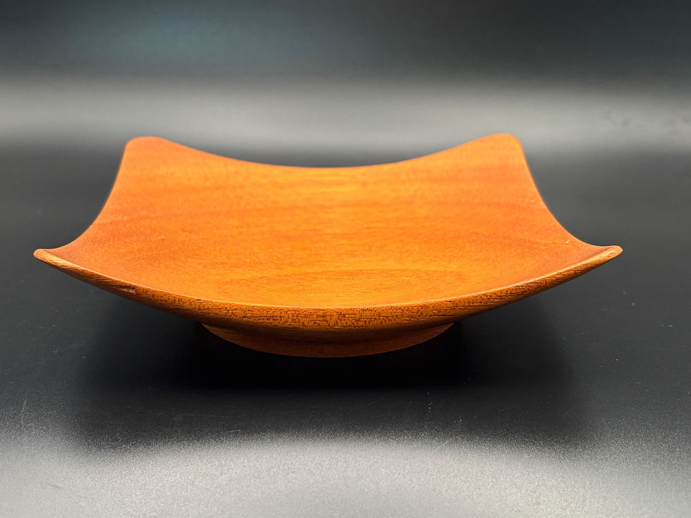 This striking square-winged bowl is handcrafted from rich Honduran Mahogany.