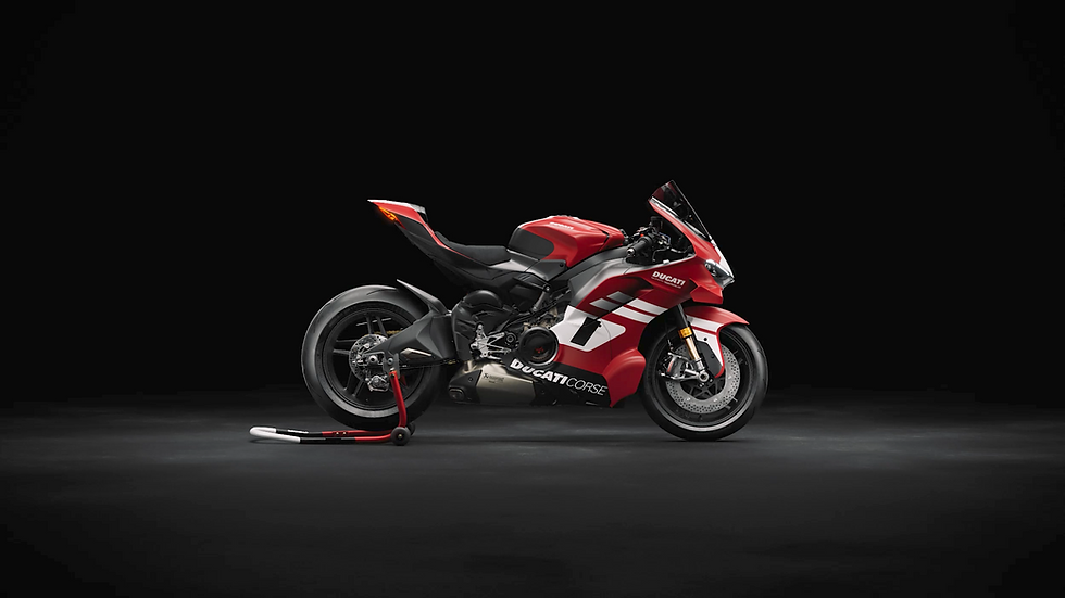 Eye-level view of Ducati Superleggera V4 Centenario parked on a racetrack, showcasing its sleek aerodynamic design and carbon fiber bodywork
