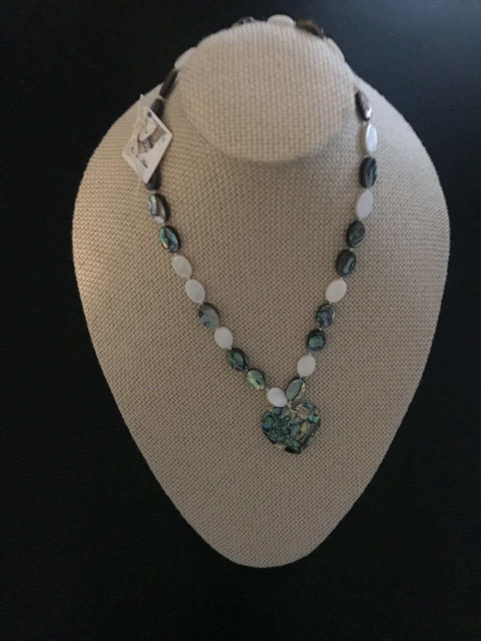 Abalone stones with a pendant of the same stone in the shape of a Heart.