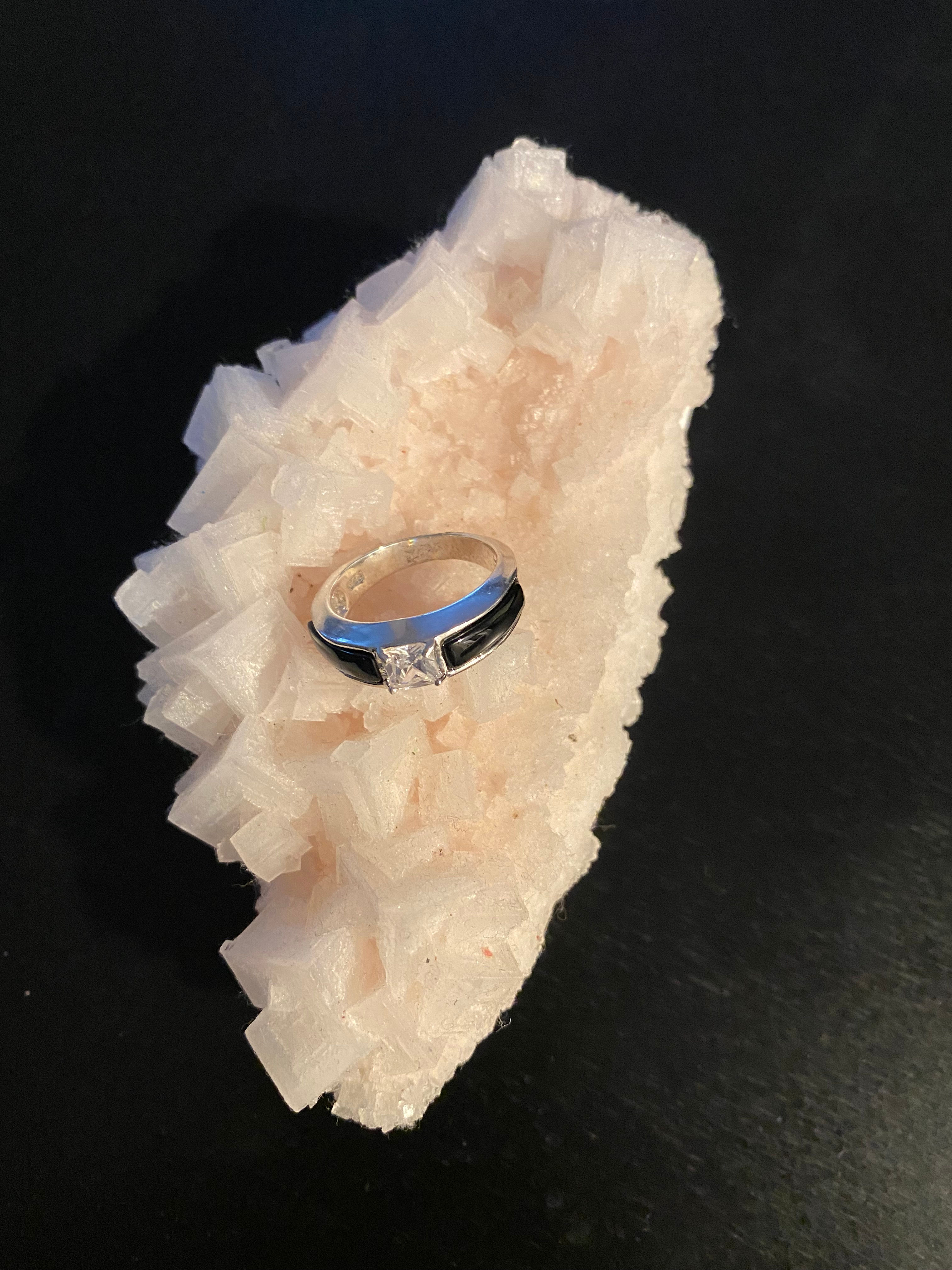 9.25 Silver Ring with Black Onix stone on both sides and center Zirconia.