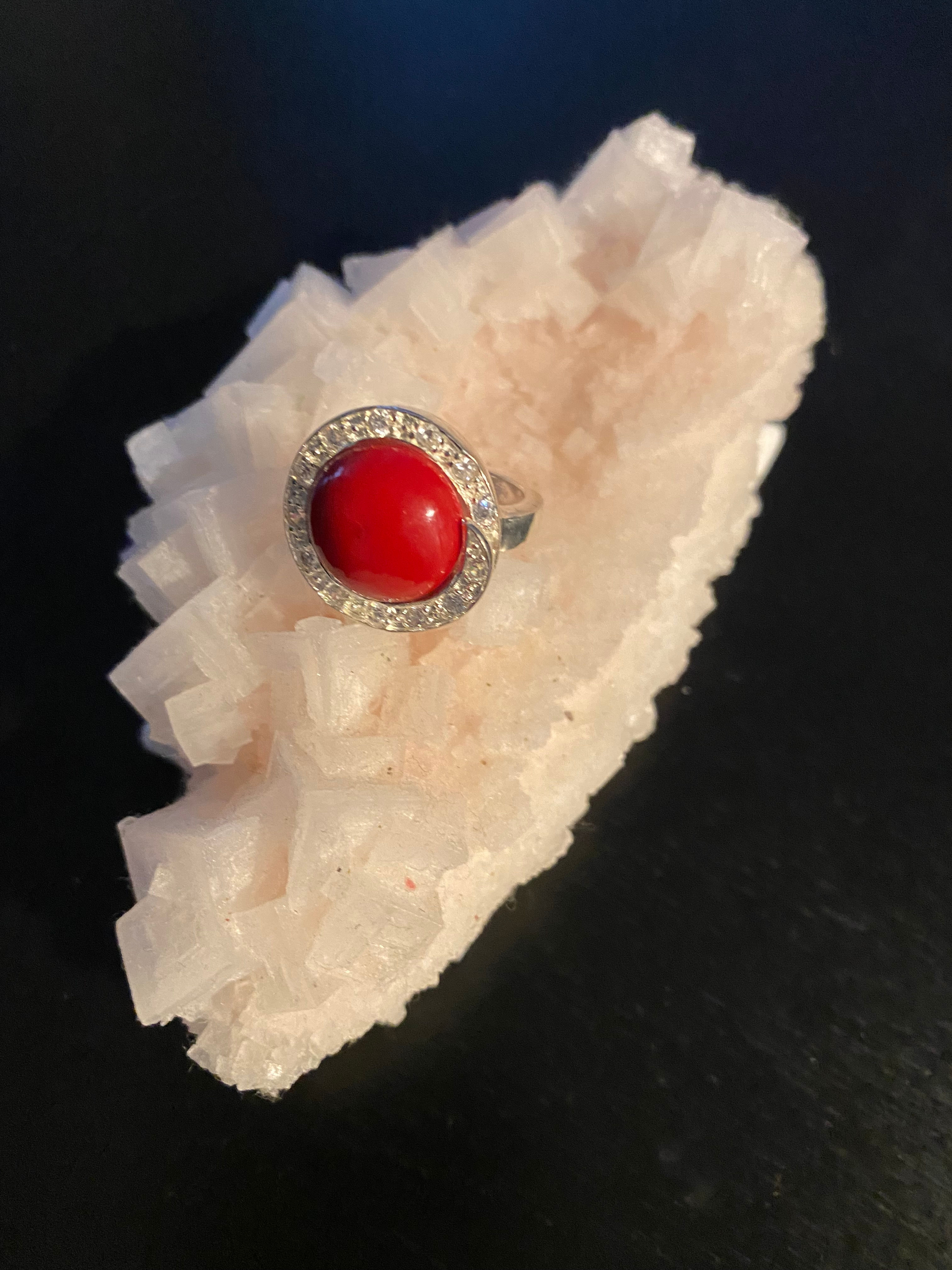 9.25 Silver Ring with Coral circle stone and row of small zirconias.