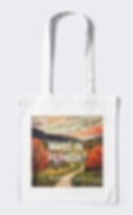 White tote bag with a woodblock print of Vermont's mountains and meadows and the text "Made in Vermont" on the front