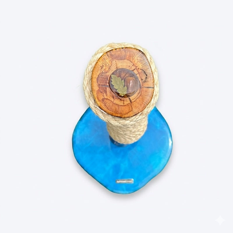 Top-down view of a bespoke cat tree showing the inlaid oak leaf and acorn emblem in clear resin.