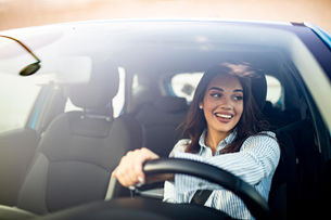 woman smiling sitting in her car