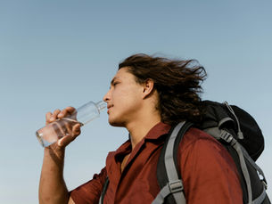 man drinking water during water fasting