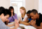 Group in prayer as they begin Bible study.