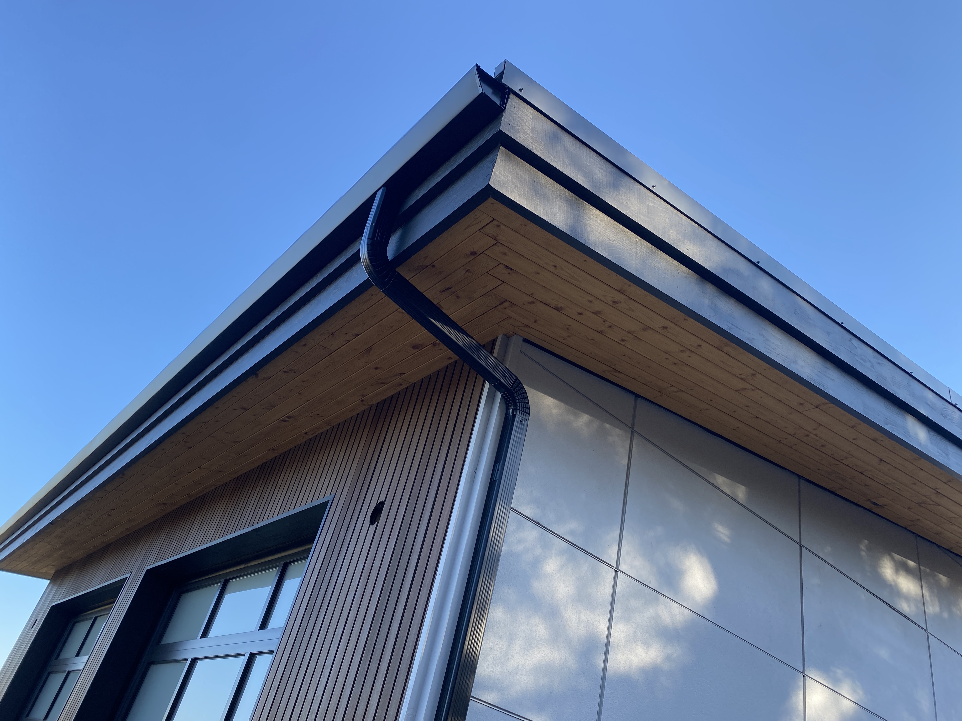Black seamless gutters installed on a modern Central Oregon home by Gutters Plus