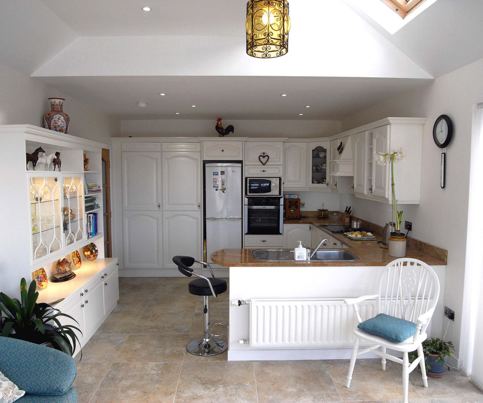Bright, open‑plan kitchen and dining area created through internal alterations and sunroom extension in Lisburn, County Down by GT Building Design.