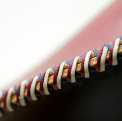 Close-up of intricate leather stitching on a glasses case