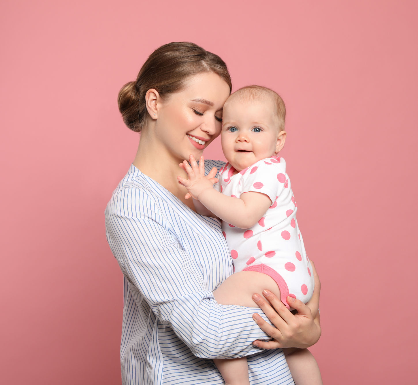 Portrait of happy mother with her baby on color background.jpg