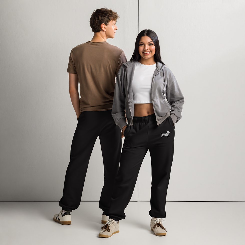 Thumbnail: Man and woman wearing black dachshund sweatpants with white embroidery, full-body view.