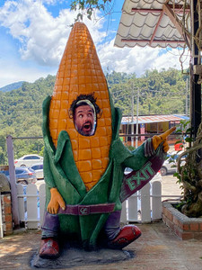 a giant plastic corn with a bit “face” hole for people to take photos