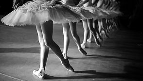 Dancers in white tutu synchronized dancing on stage. Repetition_edited.jpg
