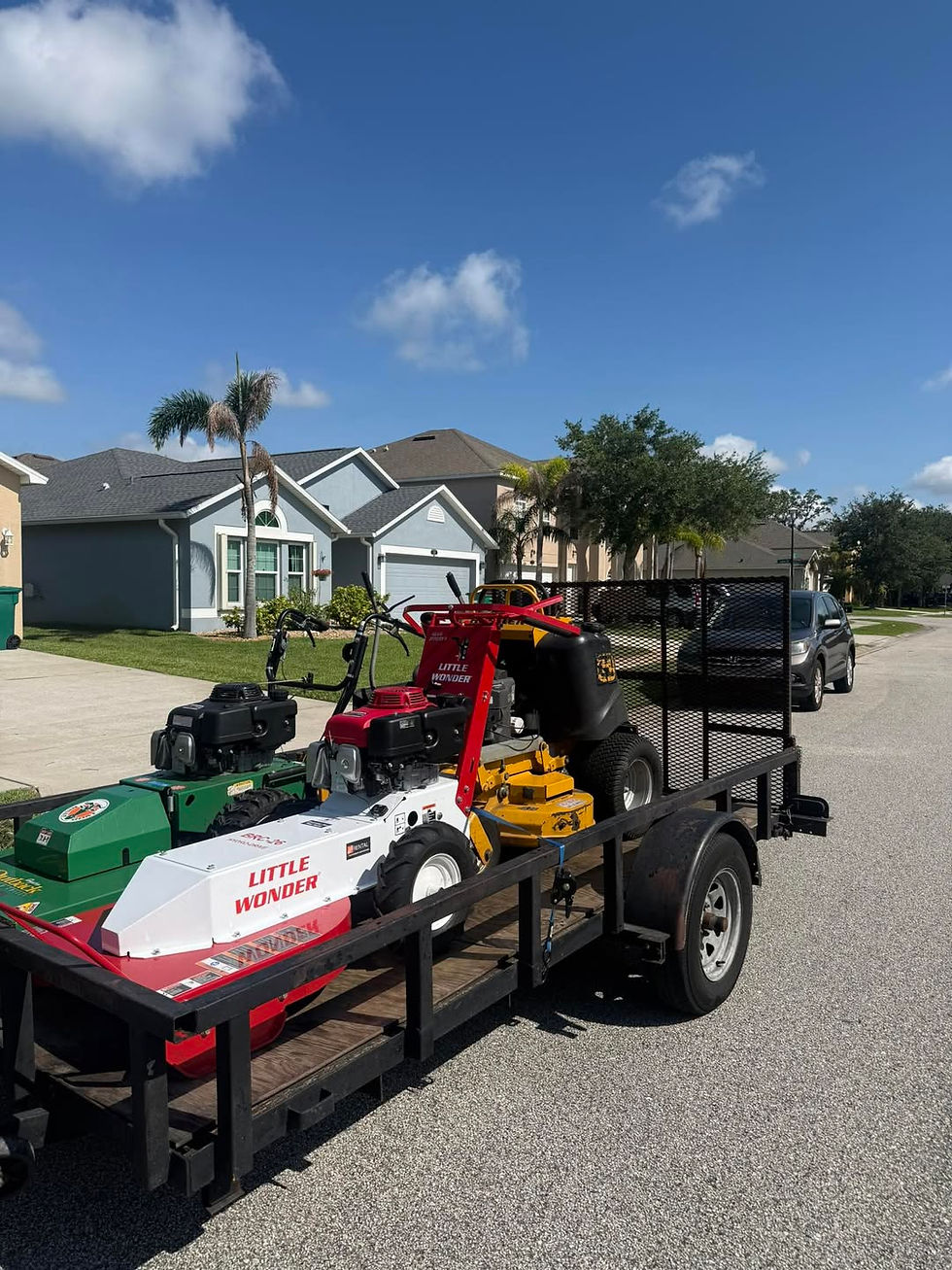 Residential and commercial lawn maintenance equipment on a trailer