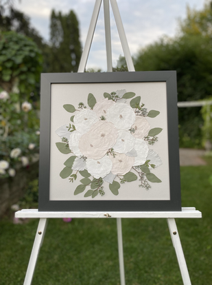 pressed wedding bouquet in a white frame with a grey background