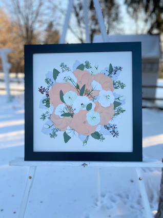 pressed wedding bouquet in a charcoal frame with a cream background