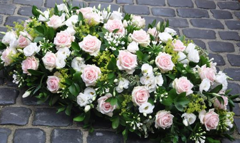 Pale Pink Roses,  Lisianthus,  scented bouvardia & vibernum with dark green foliage.
