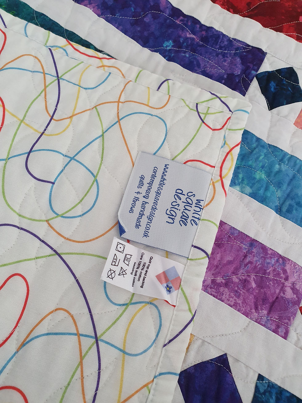 Thumbnail: colourful strip design quilt white background