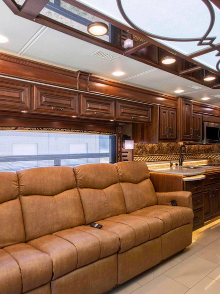 Spacious lounge area with comfortable seating in a luxury bus captured by Freddy Gann Photography