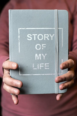 Woman holding a book titled _The Story of My Life_.jpeg
