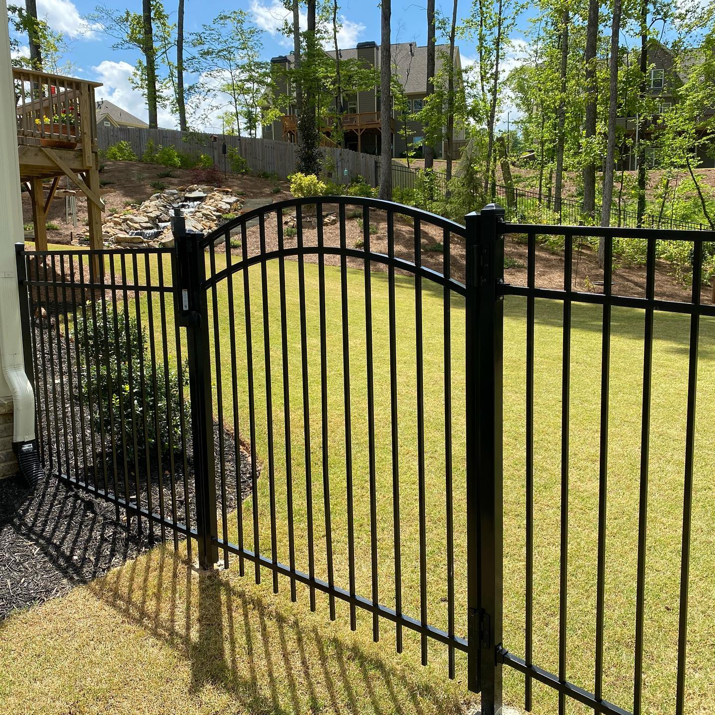Arched gate in black aluminum fence in Canton Georgia