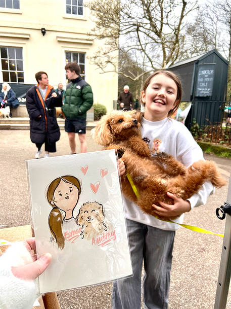 Hand with drawing of woman and dogs, girl holding fluffy dog