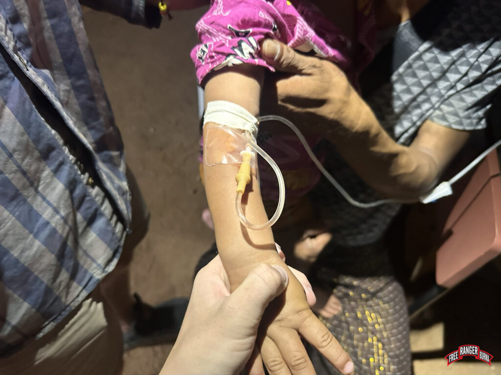 An FBR medic administers an IV to a child in the middle of the night to treat his fever and severe dehydration.