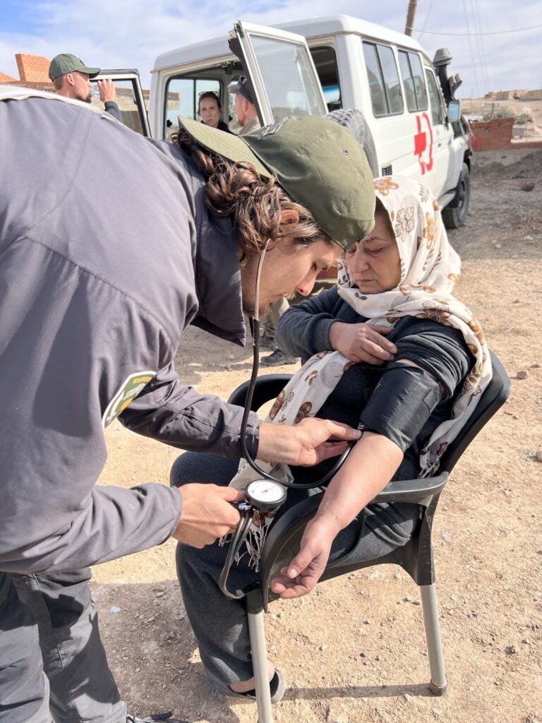FBR doctor checking blood pressure as part of an assessment for this IDP woman.