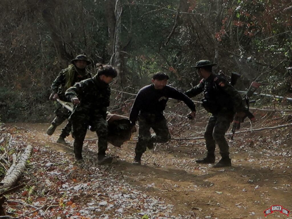 Rangers help the resistance evacuate a wounded man away from the front line.