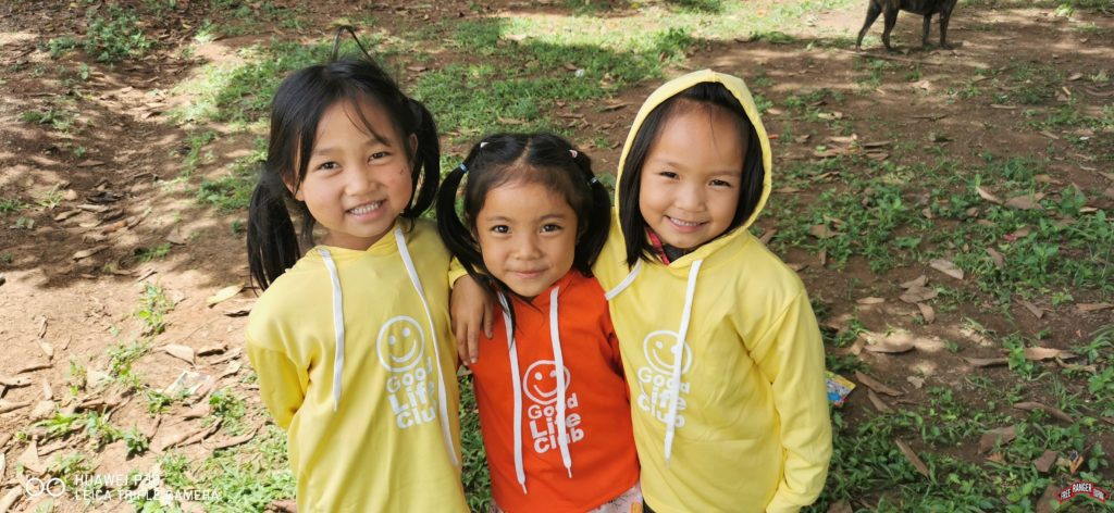 Children smiling after a GLC Program. "They were so proud of their new GLC Shirts" - Nu