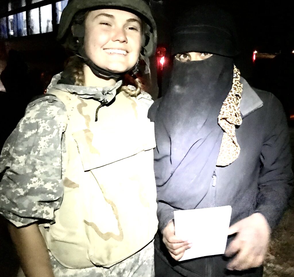 Sahale in Bagouz, Syria, with surrendered ISIS mother, and the gospel book Sahale gave her.