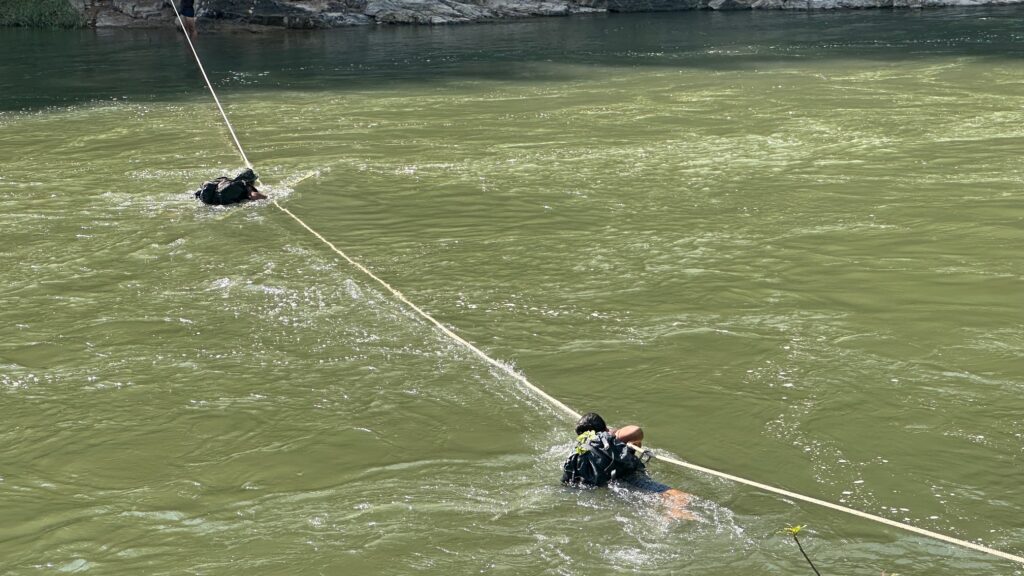 Using a rope bridge for river crossing.