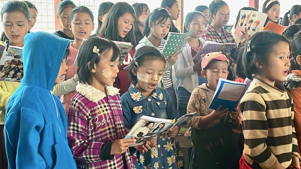 Children worship in church on the same day a villager was killed by Burma Army mortars.