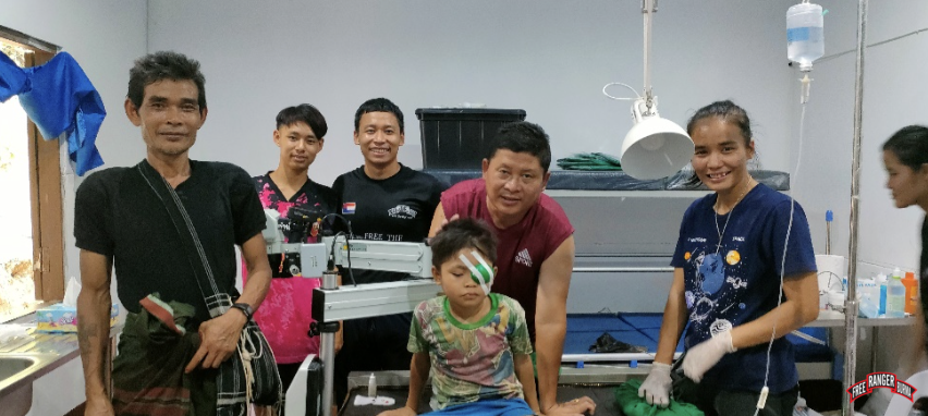 Dr. Nay Hser with Saw Wah Gay, 7-year-old boy, after his cataract surgery in both eyes. He began losing his eye sight at 2 years old, but can now see again.