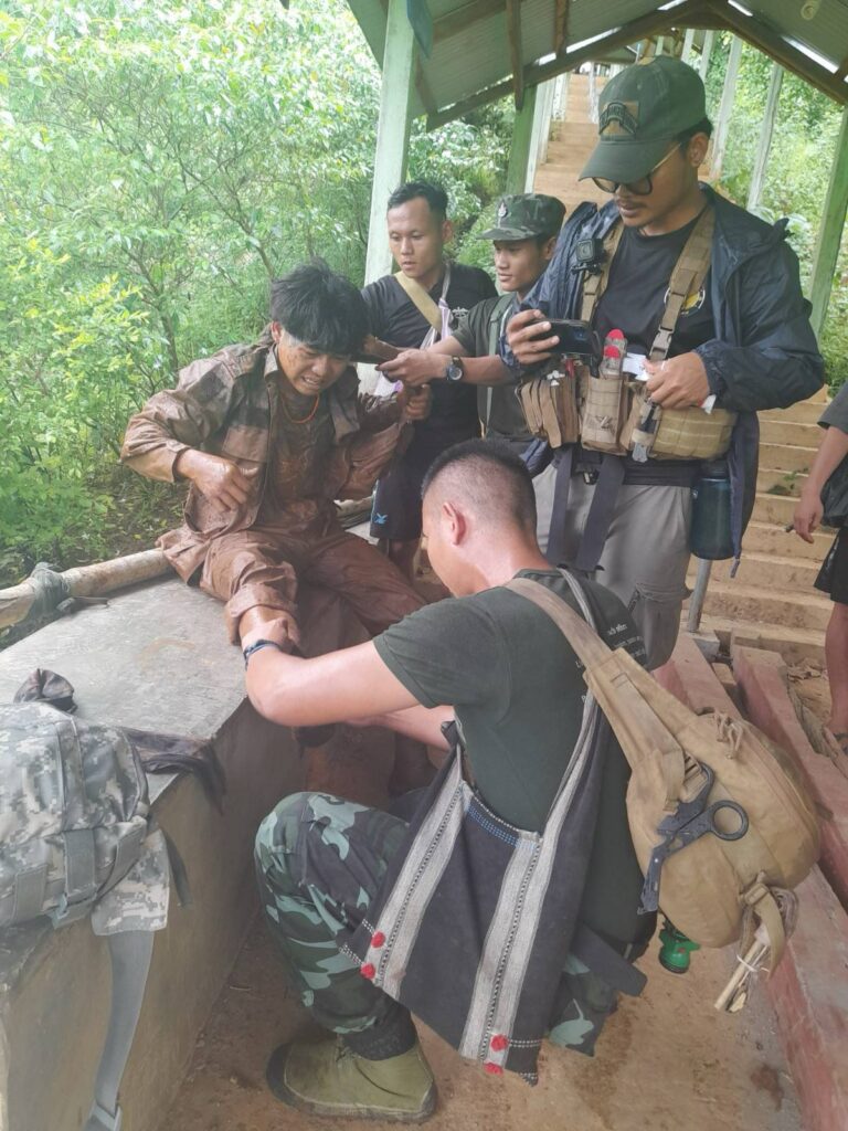 Ranger helping wounded resistance soldier.