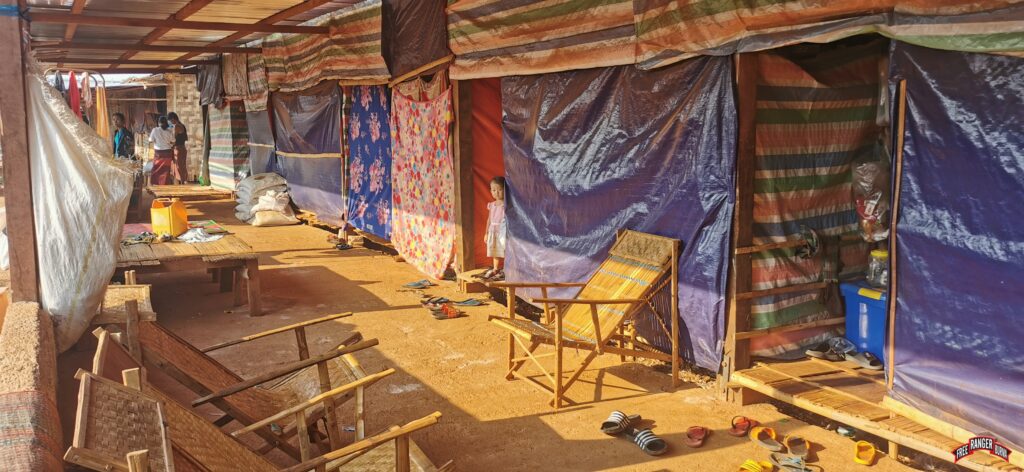 A young girl stands at her home, where multiple families live inside a temple.